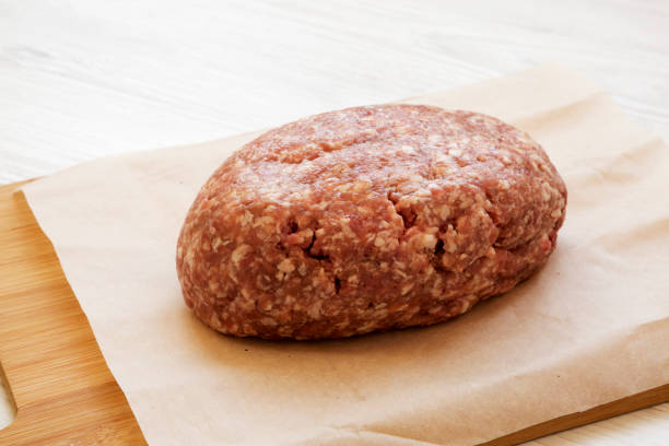 istock Fresh raw grass fed ground beef on a bamboo board, side view. Closeup. 1149622637