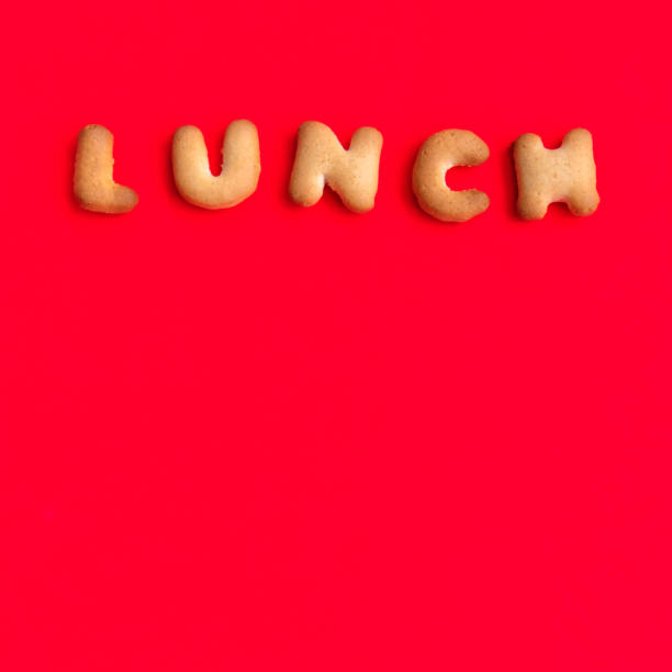 istock The Letter Word Lunch. Alphabet Cookie Cracker on red background paper texture. Red empty backgrounds. Top view, copy space, flat lay. 1149622703