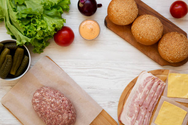 istock Cheeseburger ingredients on a white wooden background, top view. Overhead, from above, flat lay. Copy space. 1149622713