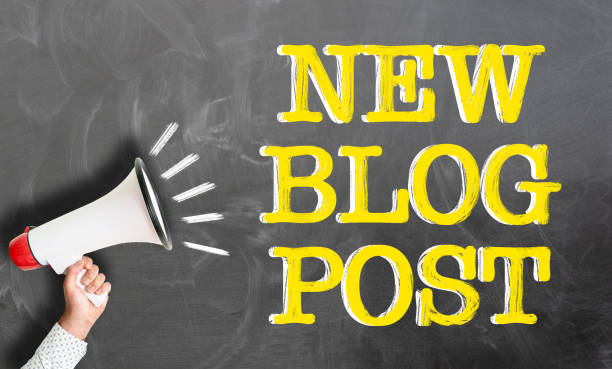 istock hand holding megaphone against text NEW BLOG POST on chalkboard 1149624430