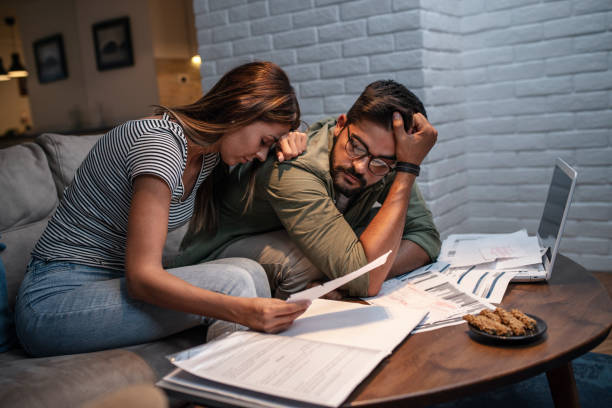 istock Worried young couple with financial bills 1149625466