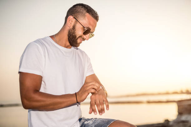istock Happy young Greek man checking time on a smart watch. 1149628351