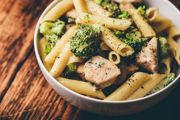 Pasta with chicken and broccoli Creamy whole wheat pasta with chicken and broccoli chicken rigatoni stock pictures, royalty-free photos & images
