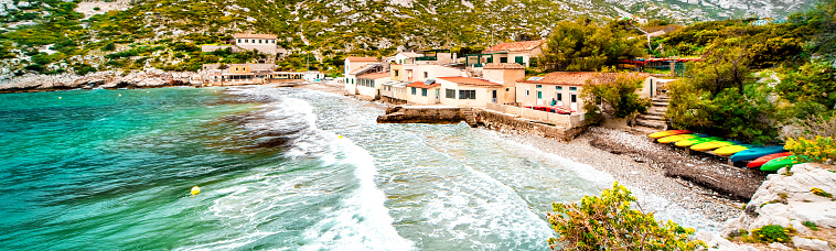 Beautiful landscape of Calanque de Sormiou, cropped image horizontal view, turquoise sea surf sea foam. South France