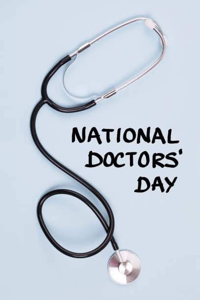Stethoscope and text National Doctors' Day on blue background