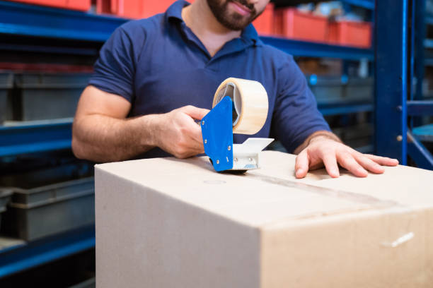 istock Midsection of manual worker packing cardboard box 1149636528