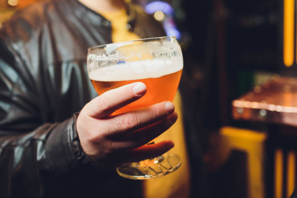 istock A man holds a beer in his hand. 1149637265
