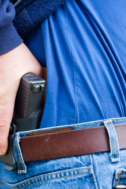 istock Concealed Carry Firearm Drawn From an Inside-the-Waistband Holster 1149655628