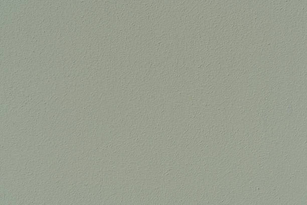 istock Plastered concrete wall, painted in gray-green, surface texture. 1149659896