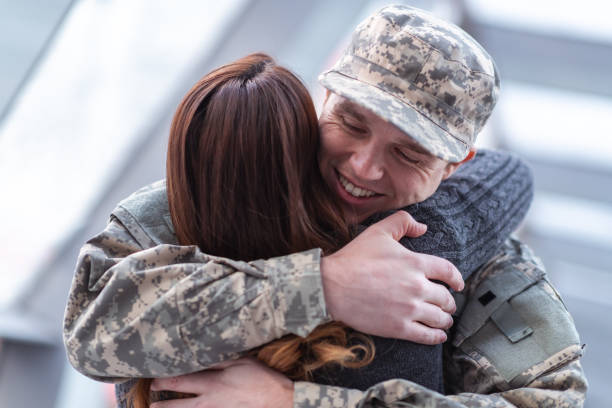 istock Woman hugging her partner after returning home from service 1149661157