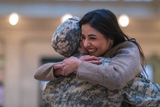 istock Woman hugging her partner after returning home from service 1149661242
