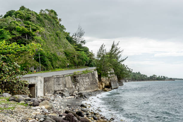 asphalt road in the countryside and coastline cliffs by the mountainside. - long bay imagens e fotografias de stock