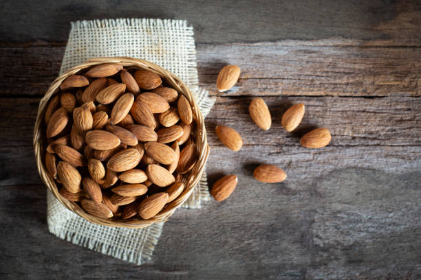 istock Almonds in wooden bowl on wood table 1149668054