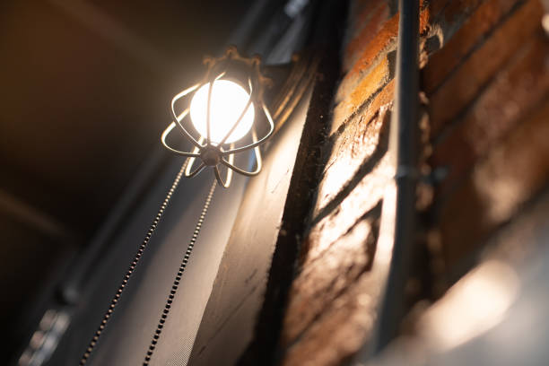 istock Antique electronic lamp, red wall lamp, high wall lamp, soft light.Red brick wall.Open chain, turn off the lights.hanging at the red brick wall in the building,Wall light brown brick,soft focus. 1149670839