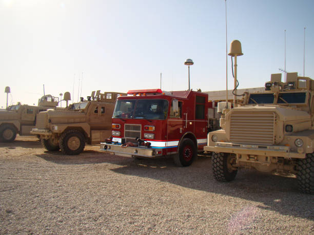 istock Fire Engine parked at a building next to Military vehicles. 1149675661