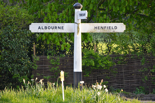 Sign post showing direction to Albourne and Henfield, both villages in Sussex, UK.