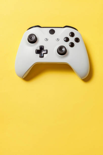 istock White joystick on yellow background. Computer gaming competition videogame control confrontation concept 1149692543