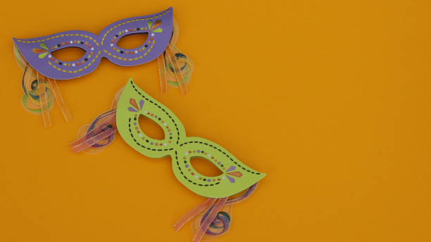 masquerade masks on an orange background