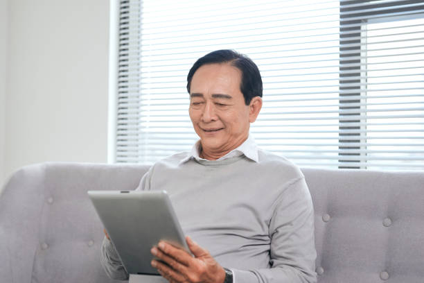 istock Happy senior relaxing at home and using tablet. 1149695608