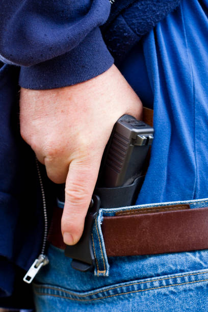 istock Concealed Carry Firearm Drawn From an Inside-the-Waistband Holster 1149695944