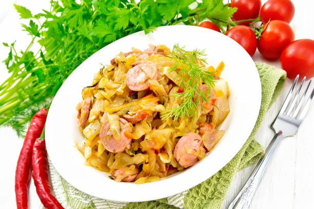 istock Cabbage stew with sausages in white plate on light board 1149695987
