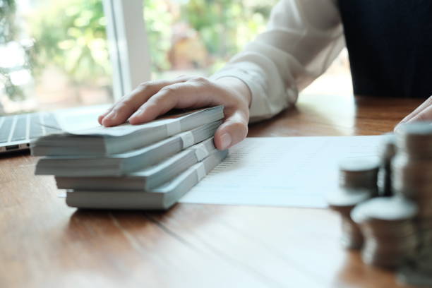 istock Businessman analyzing investment charts and pressing calculator buttons over documents. Accounting Concept  Saving Economy concept. 1149697396