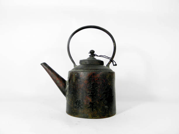 istock Old teapot made of copper on white background 1149698075