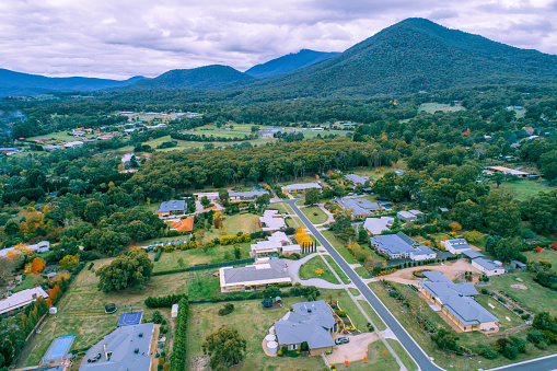 Aerial view of scenic rural living quarters among forest and mountains. Healesville, Australia
