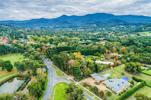 Aerial landscape of rural houses among trees in fall. Healesville, Victoria, Australia
