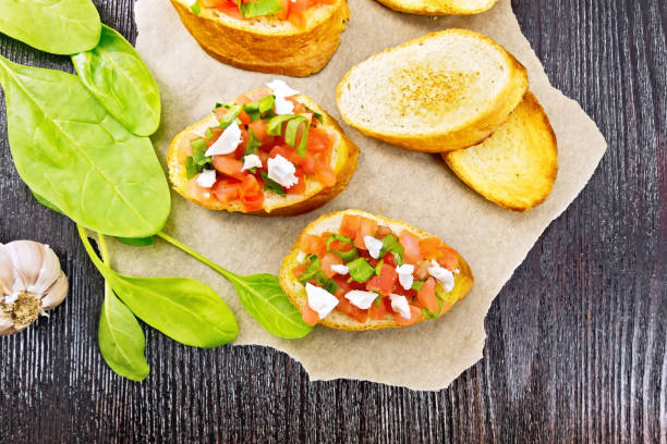 istock Bruschetta with tomato and cheese on dark board top 1149700904