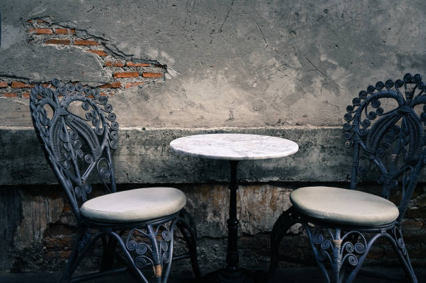 istock Vintage cafe table and chairs by the old wall 1149702171