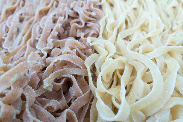 istock fresh wheet and white uncooked linguni pasta 1149702411