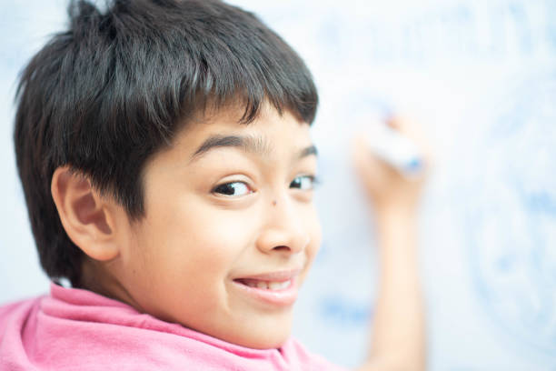 istock Little boy drawing eart on the whiteboard in the room 1149702628