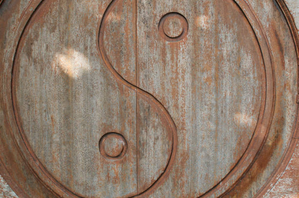 Yin-Yang symbol carved on wooden door stock photo