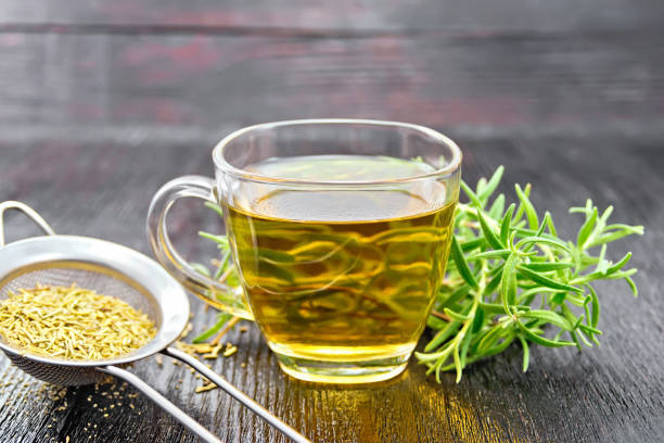 istock Tea of rosemary in cup with strainer on dark board 1149703555