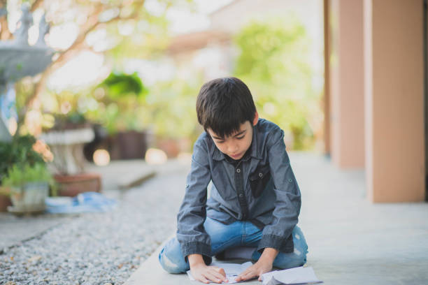 istock Little boy playing paper rocket in the park 1149705328
