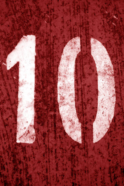 istock Number 10 in stencil on metal wall in red tone. 1149706855