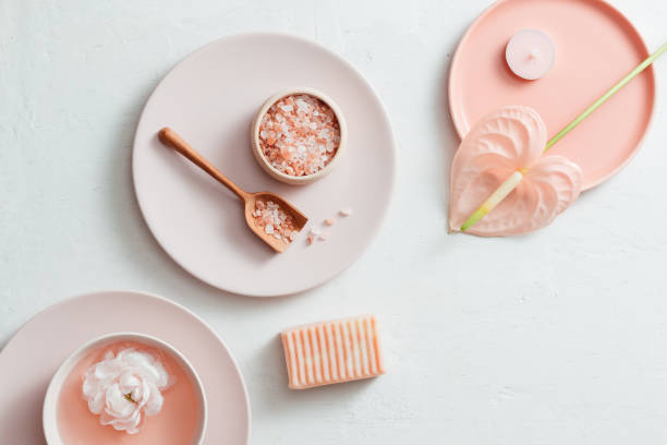 istock Top view of spa setting with salt, flower, soap on white background 1149707170