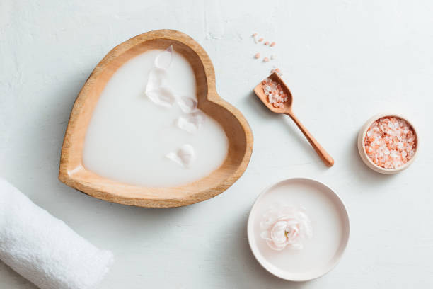 istock Spa setting with rice milk bowl, flowers, salt and towel on white background 1149707201