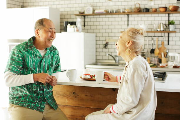 istock senior couple sitting on a stool in kitchen dining 1149708047