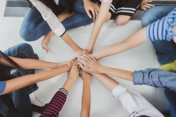 istock Group of student's friendship and team work hand on hand 1149708143