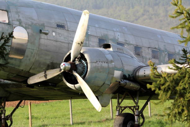 istock Left rotary engine of Douglas Dakota DC-3 WWII plane placed in field at exhibit surrounded with uncut grass and trees 1149710183