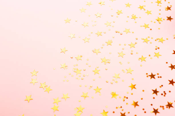 istock Gold star shape confetti on pink background. 1149712240