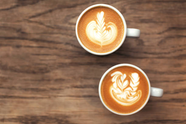 istock Two cups of coffee on wood table. 1149712486