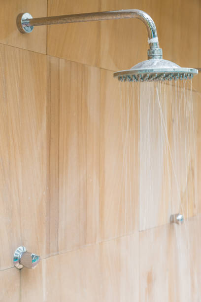 istock Outdoor shower sprinkler on brown wall 1149713587