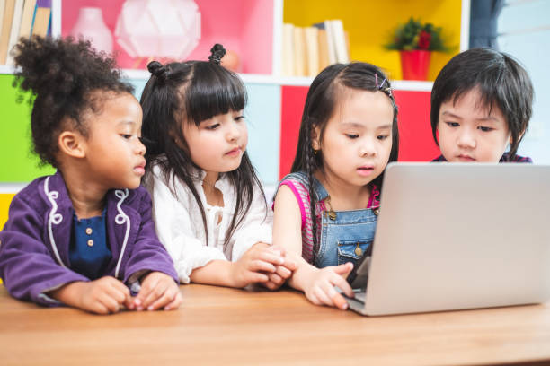 istock Group of students kids using laptop for learning in classroom, kids education concept 1149715994
