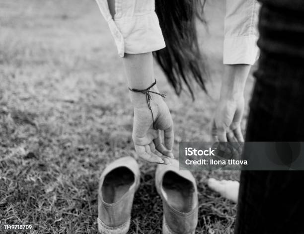 Womens Hands Hang Over The Espadrilles Stock Photo - Download Image Now - Adult, Adults Only, Arm