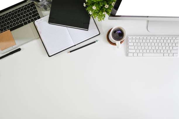 istock Office desk computer, laptop, coffee, notebook with pen on above table. 1149719107