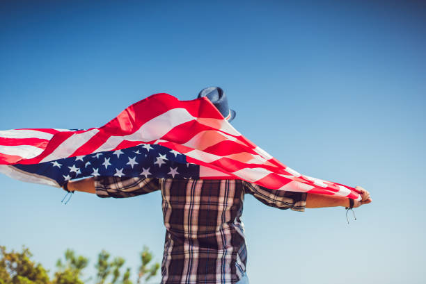 istock Young man holding USA flag 1149724386