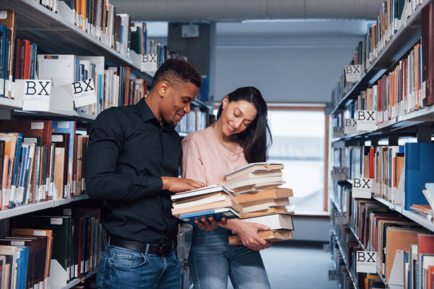 istock Multiracial students in the library searching for the information together 1149724979